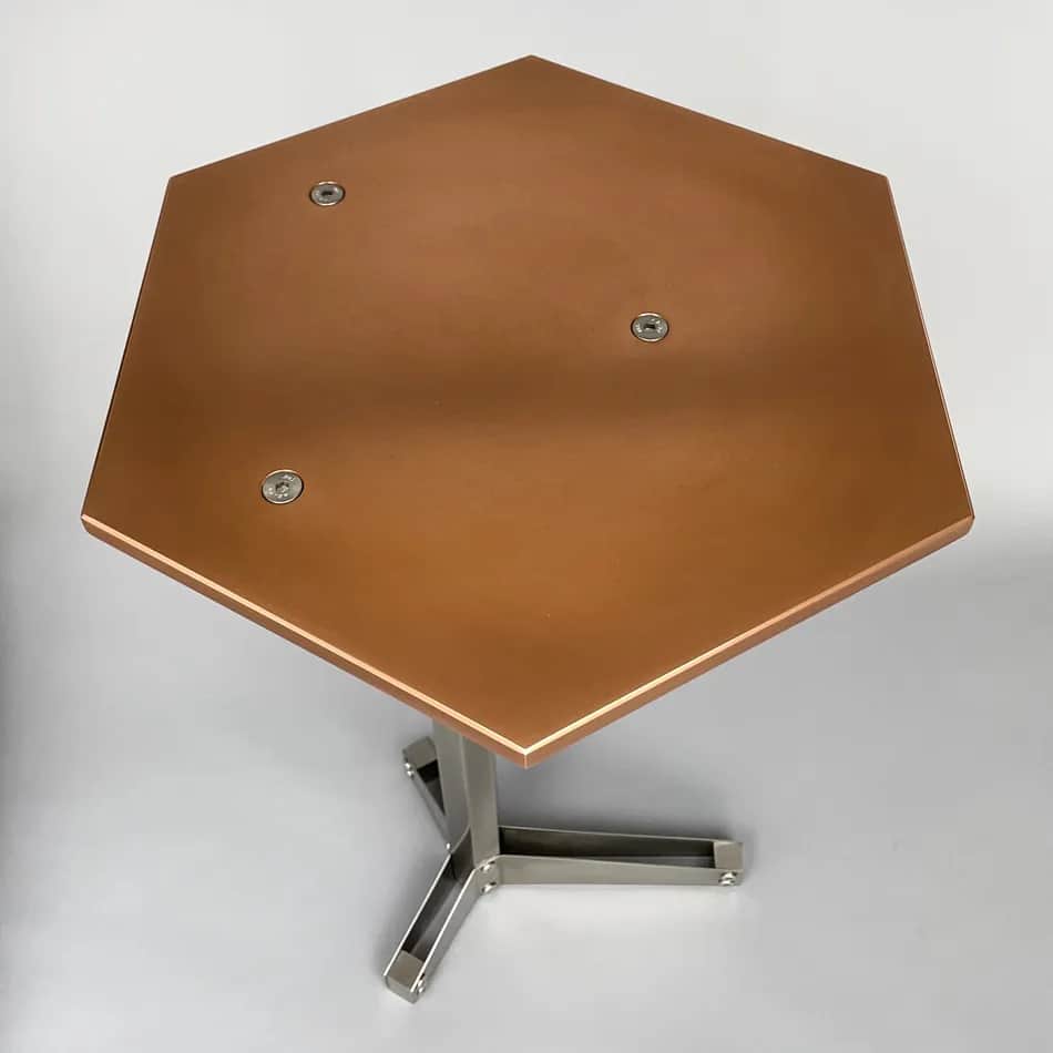 A hexagonal side table with a copper-colored top and a brushed metal pedestal base. The top is secur… — 3D model