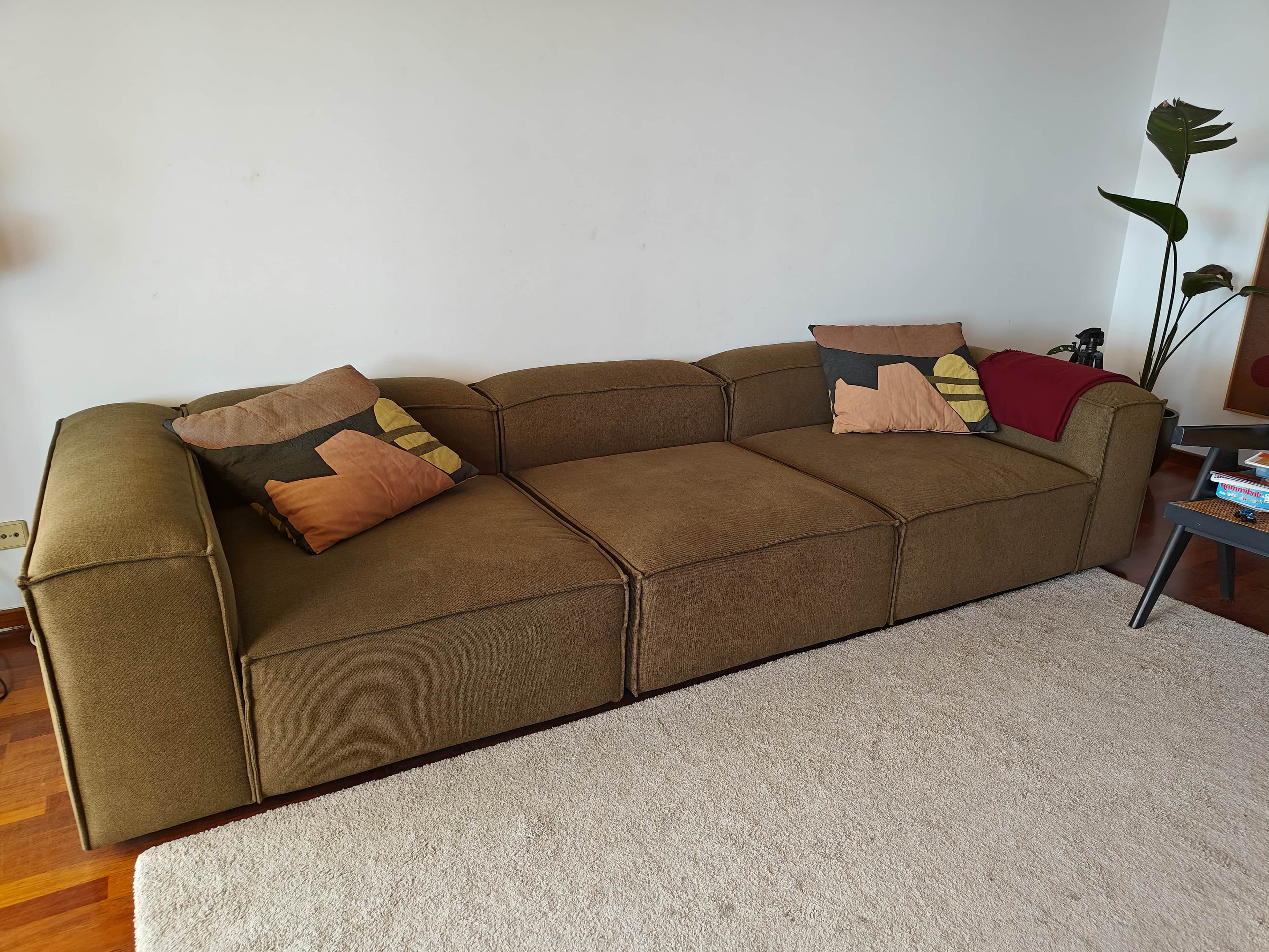 A contemporary modular sectional sofa featuring three distinct upholstered units, arranged in a stra… — 3D model