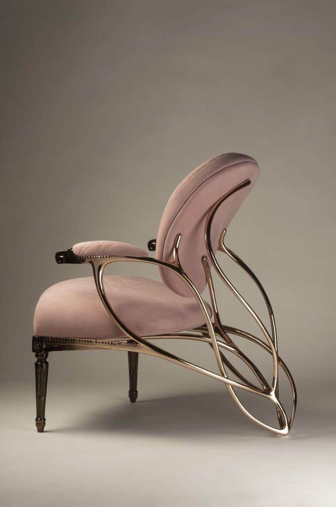 A contemporary lounge armchair featuring a dramatic sculptural frame crafted from gilded metal, supp… — free OBJ 3D model
