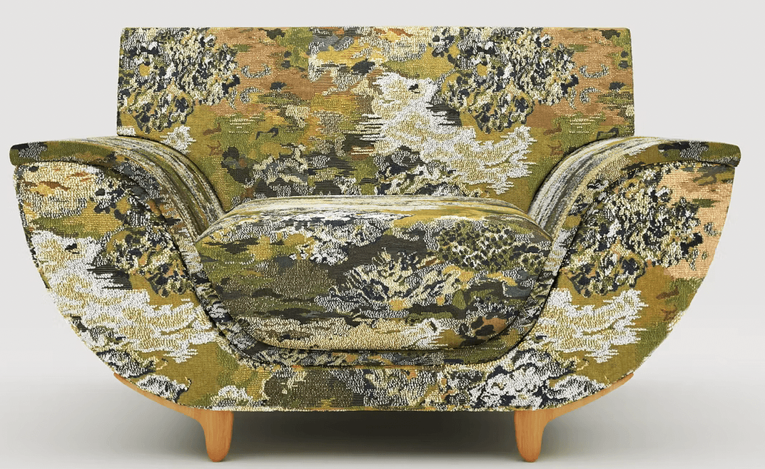 A single armchair upholstered in a textured fabric with a dense, abstract pattern featuring shades o… — 3D model