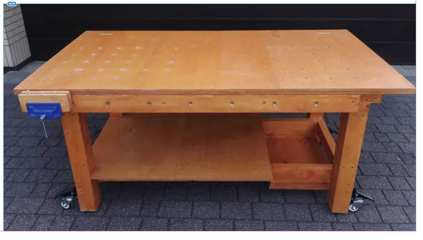 A rectangular wooden workbench featuring a light-colored wood construction, a perforated work surfac… — 3D model