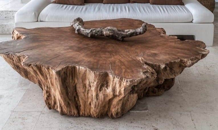 A low-profile coffee table crafted from a single, thick slab of natural wood, likely a root section,… — 3D model