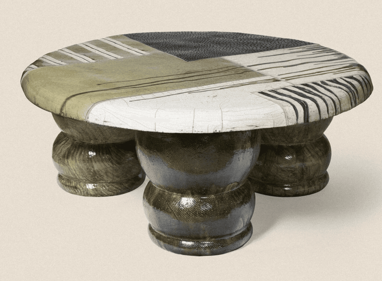 A low-profile coffee table with an oval, irregularly shaped top. The tabletop is segmented with vari… — 3D model