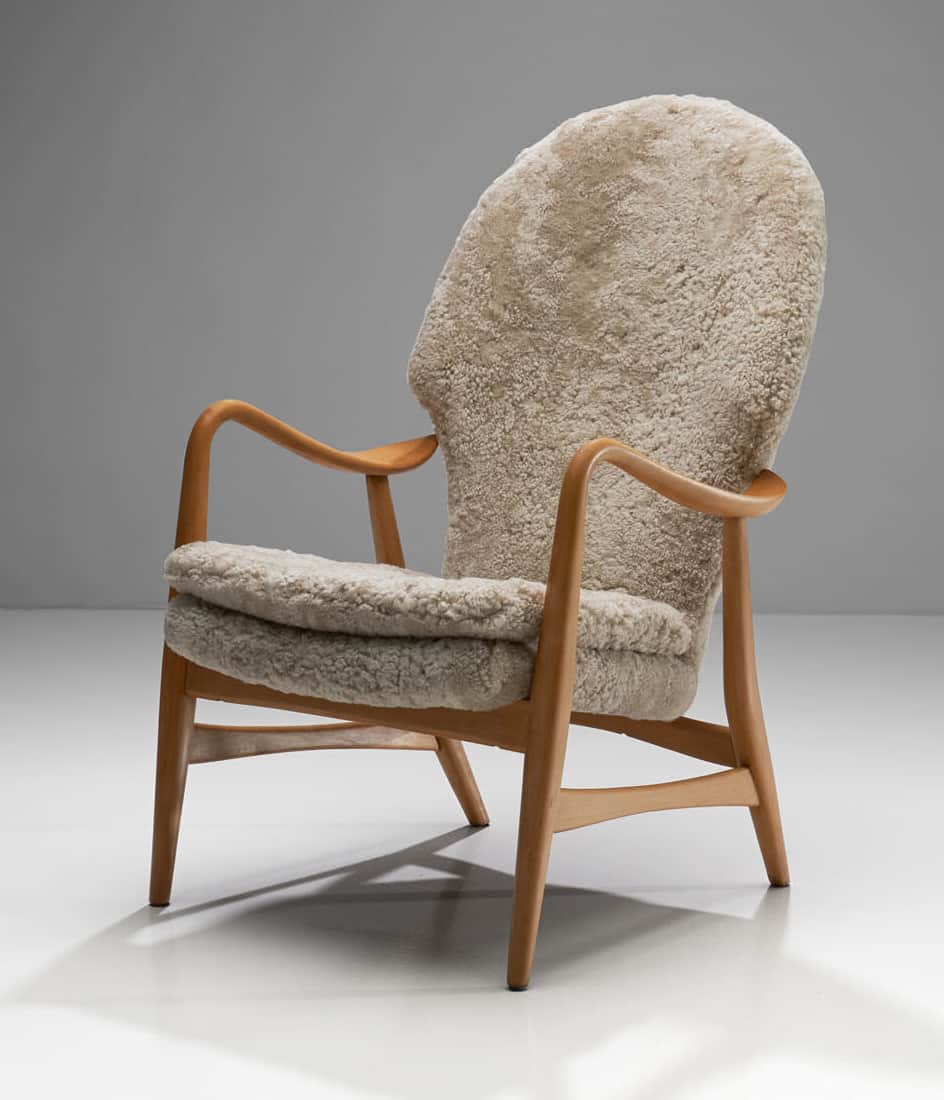 A high-backed armchair with a wooden frame and plush sheepskin upholstery. The frame consists of cur… — free FBX 3D model