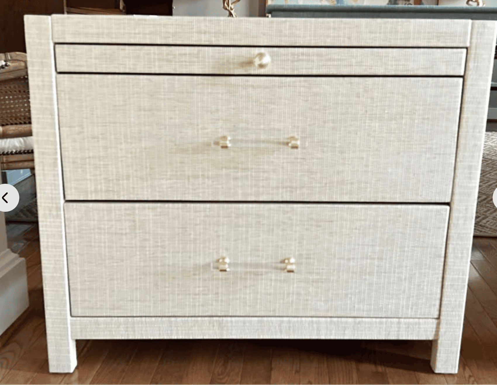 A compact chest of drawers with three visible drawers. The exterior has a textured linen-like finish… — 3D model