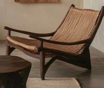 A modern armchair featuring a dark wood frame with gracefully curved legs and armrests. The seat and… — 3D model