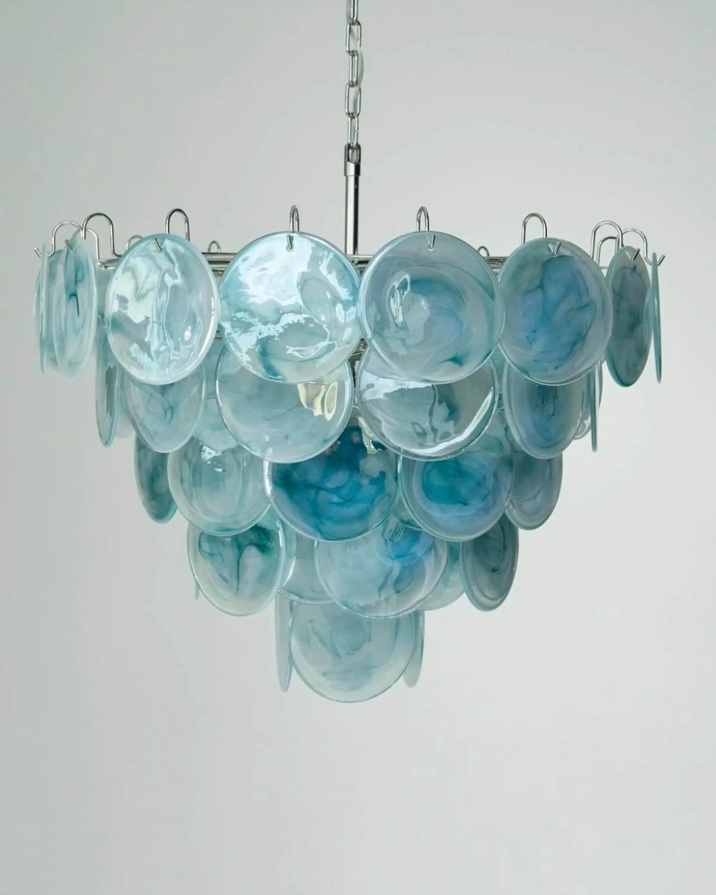A ceiling-mounted chandelier featuring multiple tiers of circular, flat discs in a blue and white ma… — 3D model