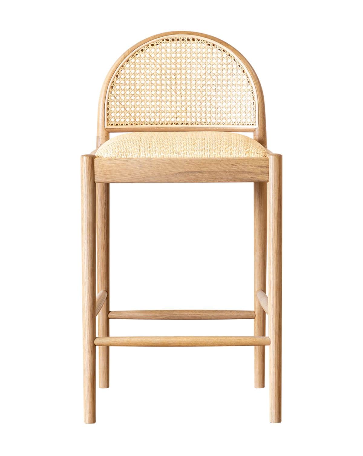 A light-toned wooden bar stool featuring an arched backrest with cane webbing and a seat upholstered… — 3D model