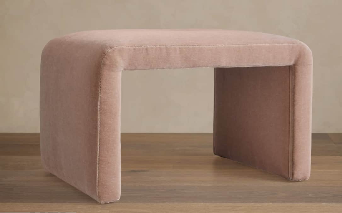 A contemporary U-shaped ottoman, fully upholstered in a light taupe velvet-like fabric. The design f… — 3D model