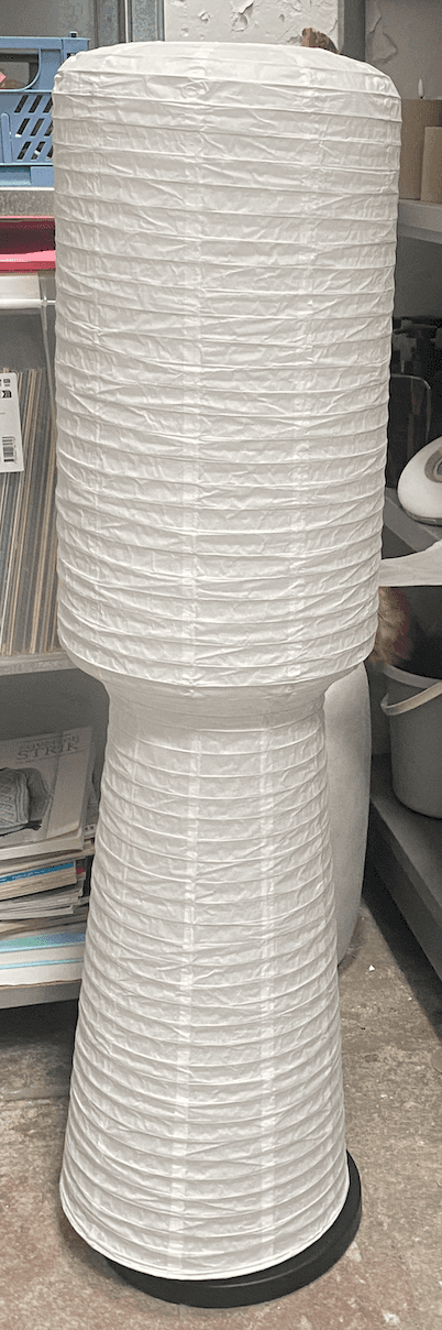 A floor lamp with a cylindrical, accordion-pleated shade atop a tapering base, also with accordion p… — 3D model