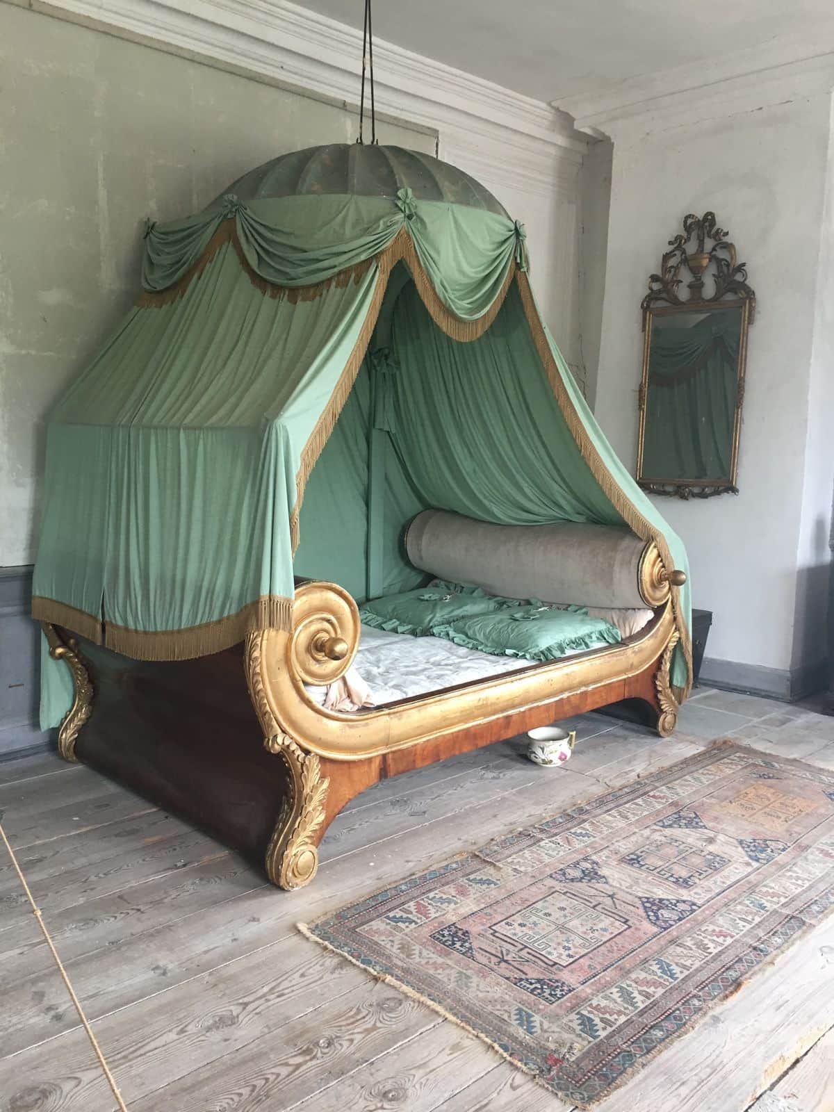 An opulent Empire-style daybed featuring a dark wood base with extensive gilded scrollwork, topped w… — 3D model