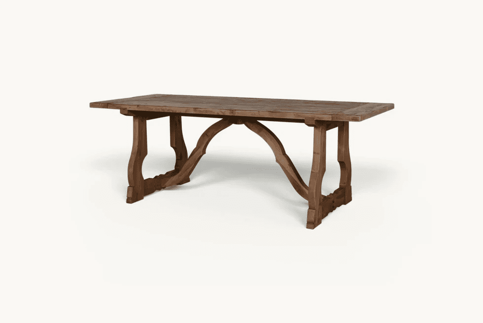 A long, rectangular rustic wooden table with a distinctive arched trestle base. — 3D model