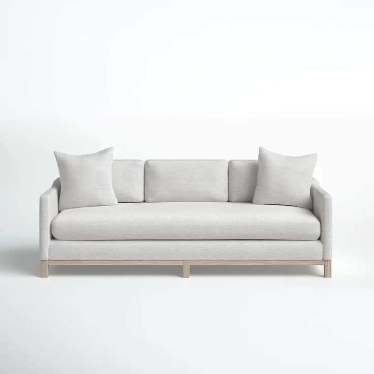 A contemporary three-seater sofa featuring light grey textured upholstery, track arms, and an expose… — 3D model