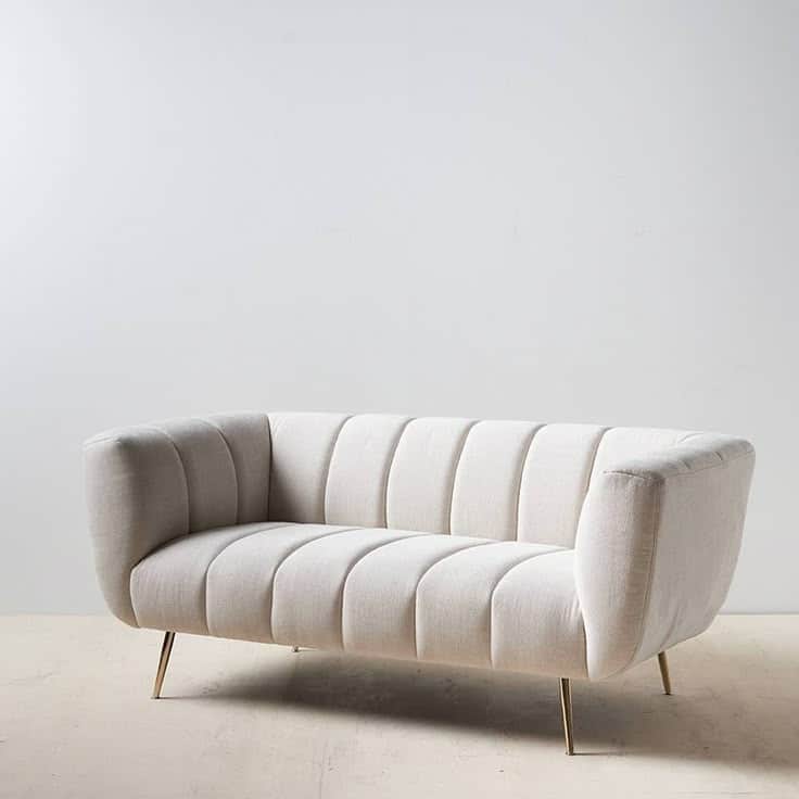 A two-seater sofa with a curved back and arms. The seat and back are upholstered and feature vertica… — free GLTF 3D model