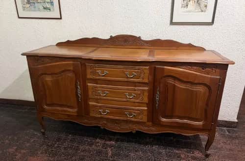A classic French Provincial style wooden sideboard with a rich, warm brown finish. It features a ser… — 3D model