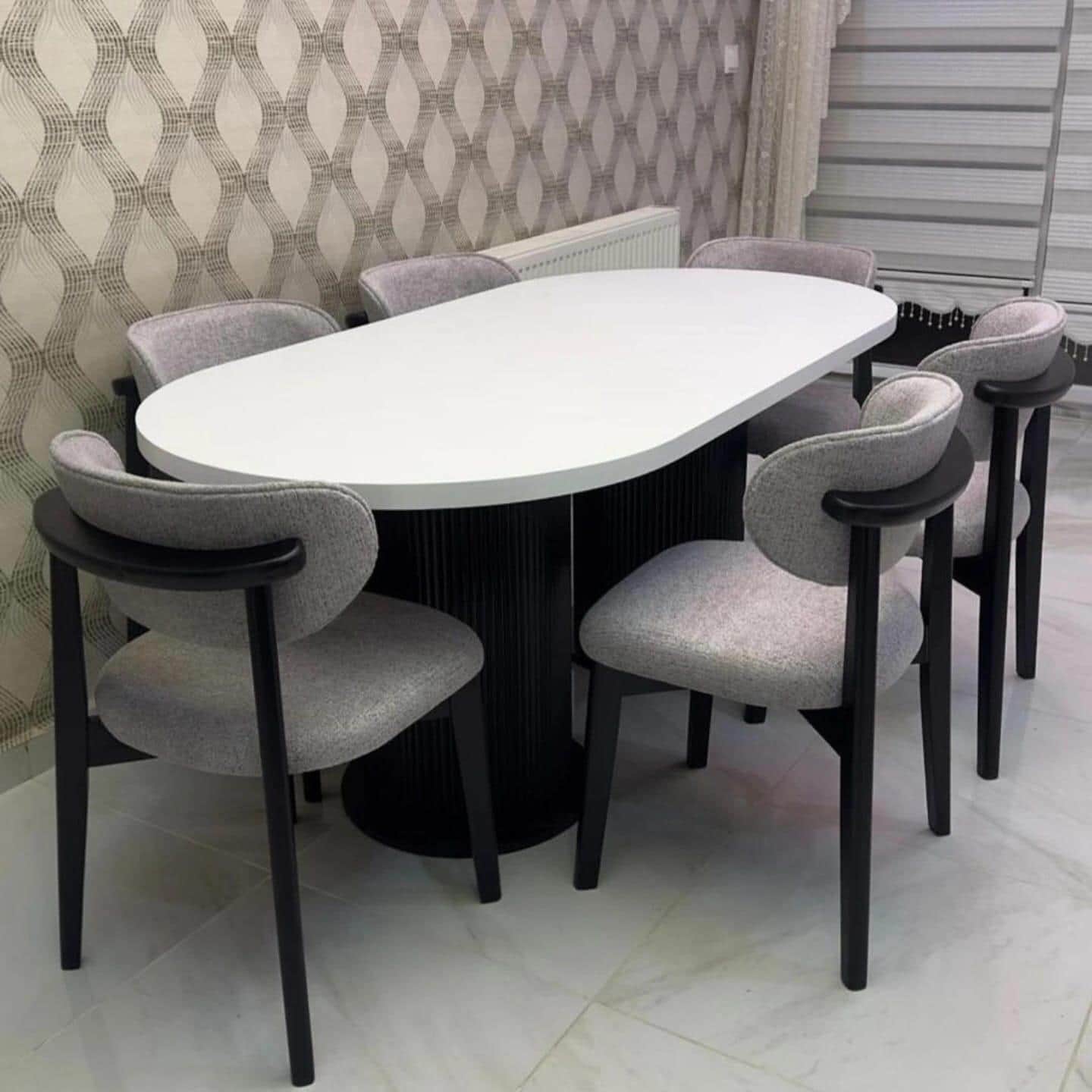 A modern dining set featuring an oval-shaped, white tabletop supported by a fluted cylindrical pedes… — free SKP 3D model