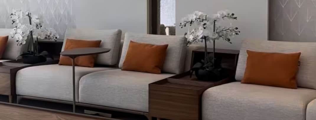 A modern modular sectional sofa featuring light-colored fabric upholstery, integrated dark wood tabl… — 3D model