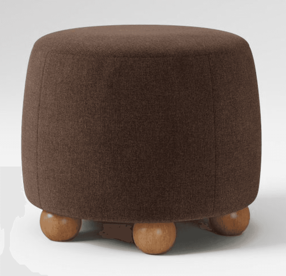 A round, upholstered ottoman with a curved body and three spherical wooden legs. — 3D model