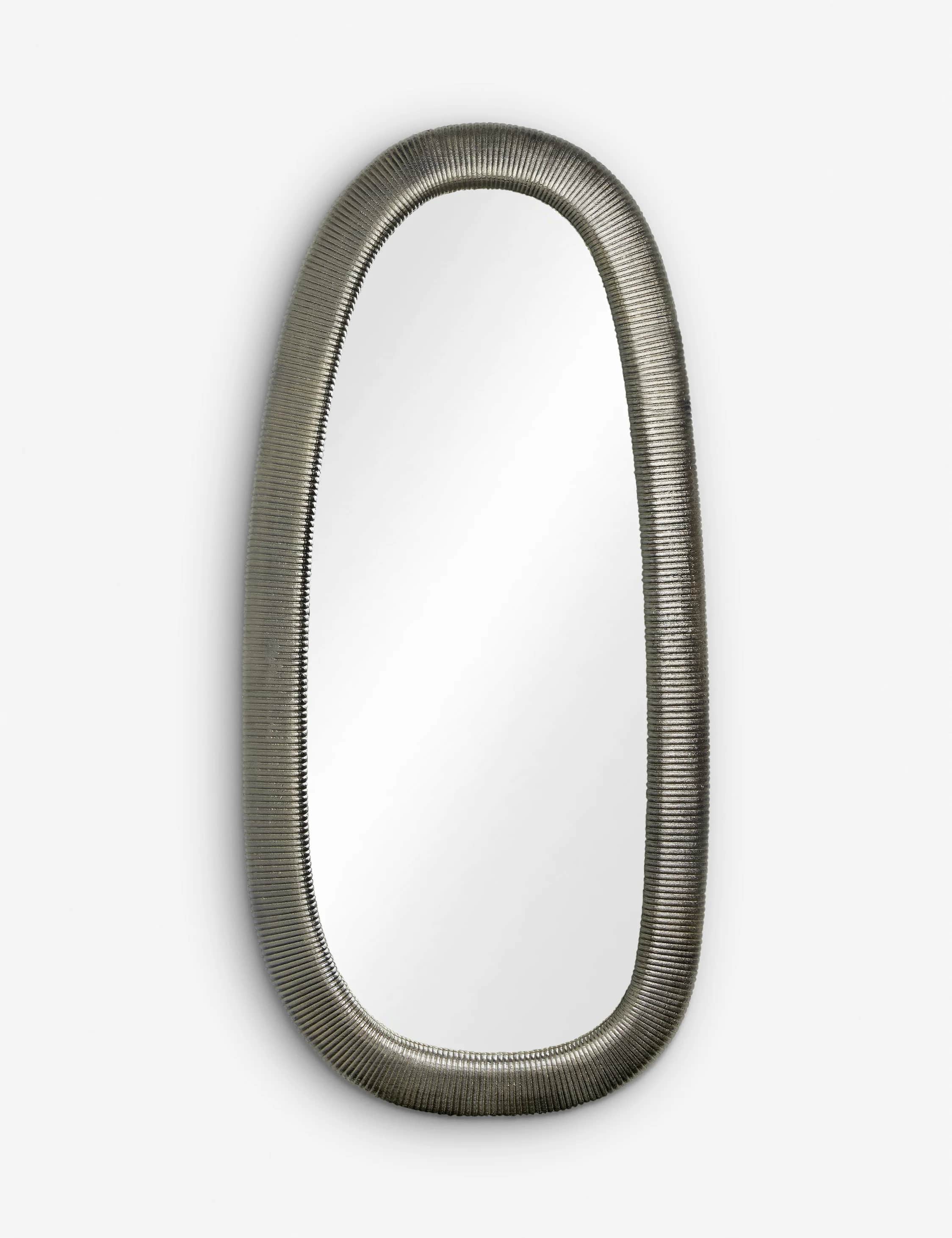 An oval mirror with a textured, metallic frame that resembles a flexible conduit or ribbed tube. The… — 3D model