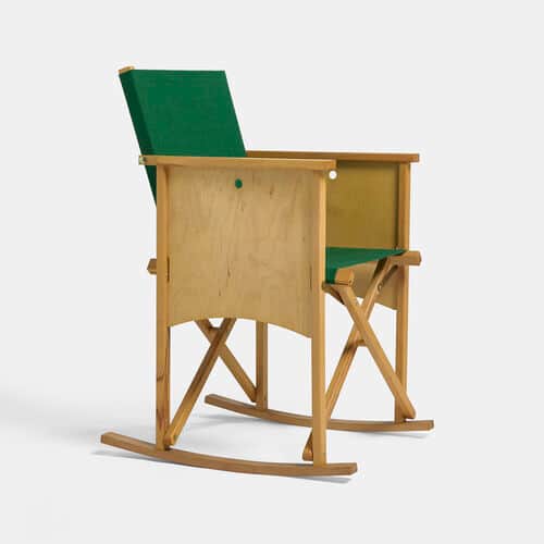 A rocking chair with a light-toned wooden frame, distinct plywood side panels, and a green fabric se… — 3D model