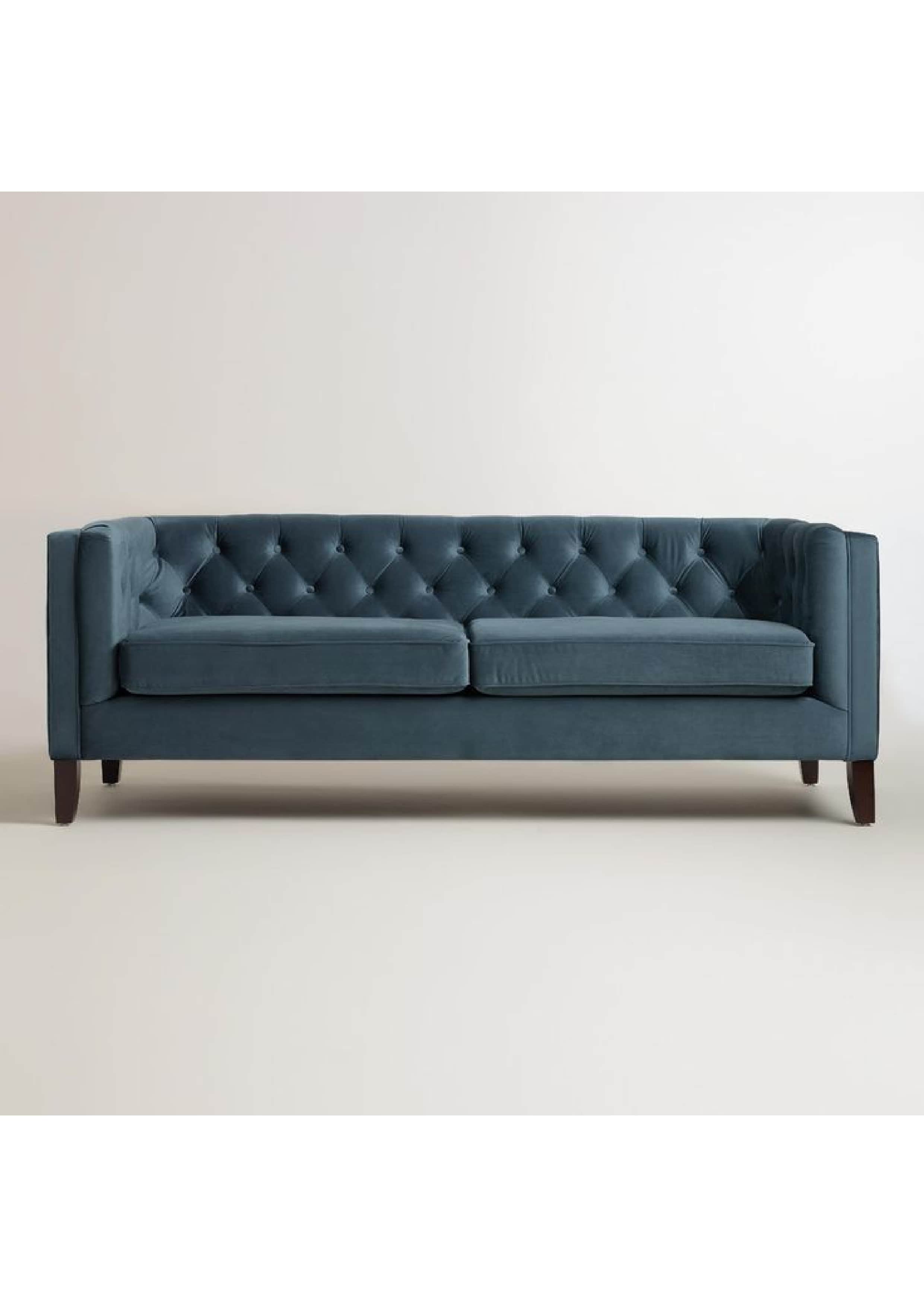 A contemporary three-seater sofa upholstered in deep blue velvet, featuring a button-tufted backrest… — 3D model
