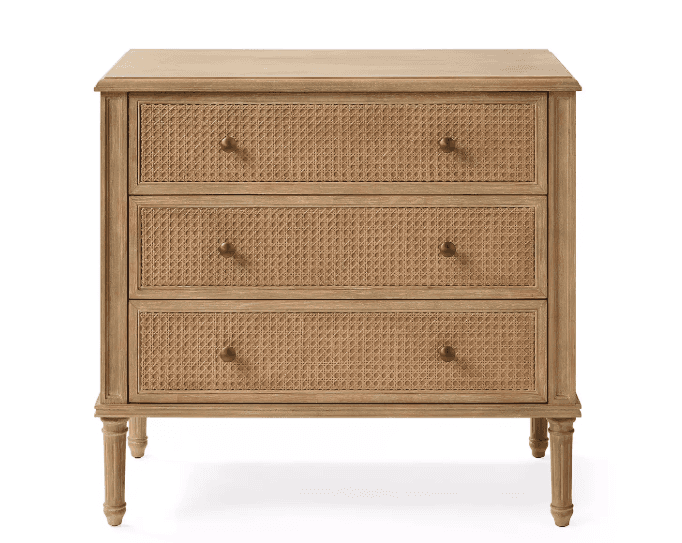 A light wood chest of drawers featuring three drawers with woven rattan fronts, supported by four el… — 3D model