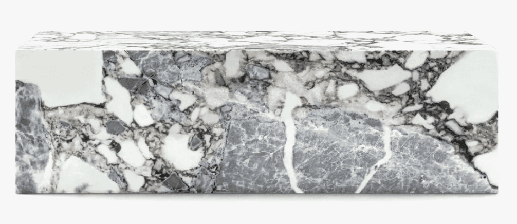 A rectangular block-shaped coffee table constructed from a composite of variegated marble, featuring… — 3D model