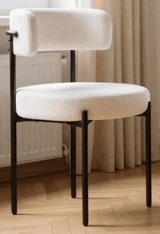 A modern accent chair with a black metal frame and a plush, textured cream-colored upholstery. The s… — 3D model