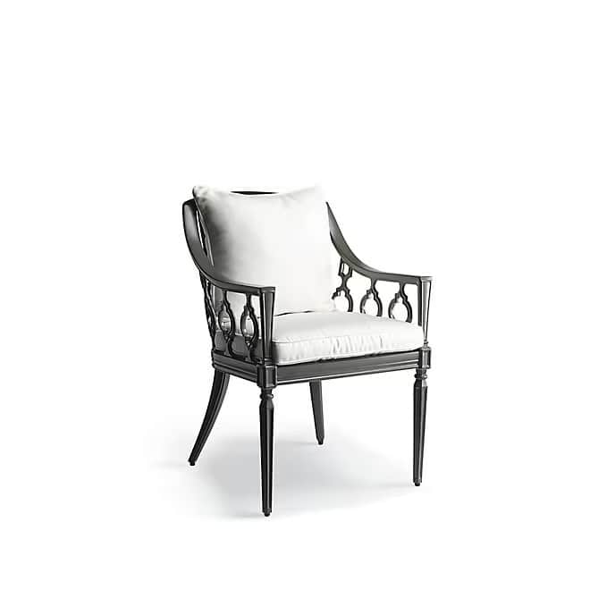 A dark-colored, ornate cast metal armchair featuring intricate decorative side panels and legs. The… — 3D model