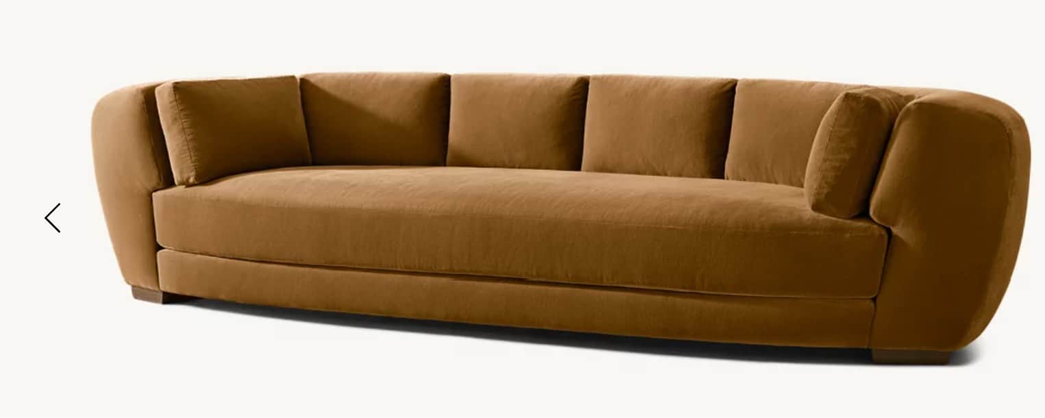 A contemporary, elongated sofa featuring a distinctively curved silhouette. It is upholstered in a r… — 3D model