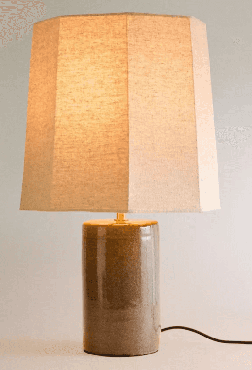 A contemporary table lamp featuring a cylindrical ceramic base with a speckled brown glaze and an oc… — 3D model
