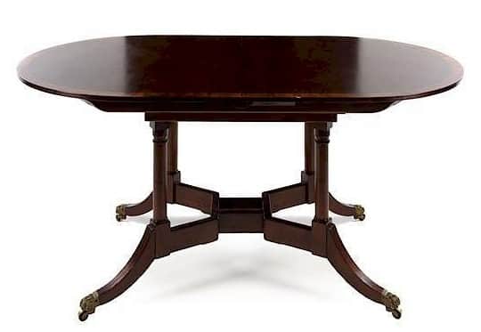 A dark finished, possibly mahogany, dining table featuring an oval top, likely an extension or drop-… — free OBJ 3D model