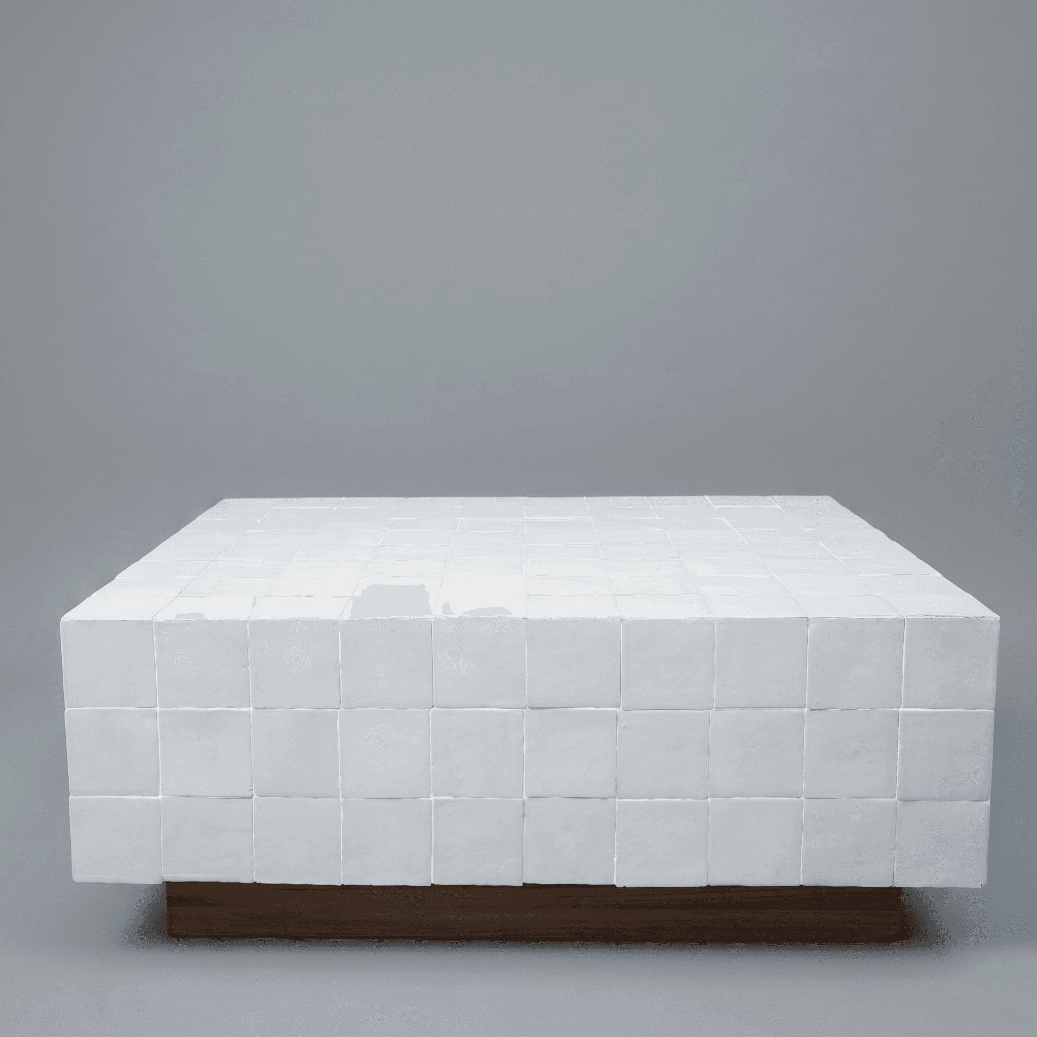A low-profile, rectangular coffee table with a top and sides clad in small, square white tiles. The… — free OBJ 3D model
