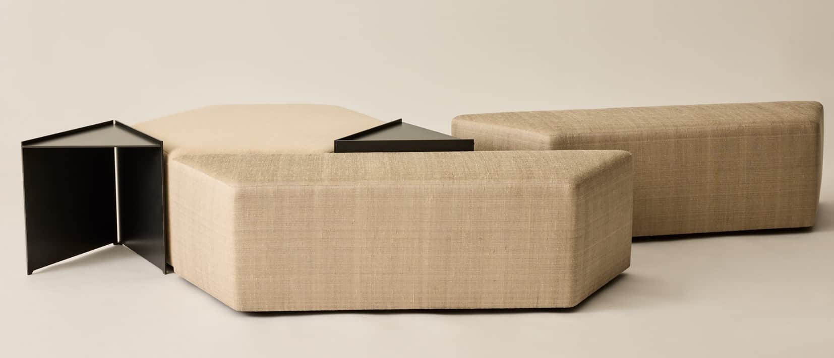 A modular seating arrangement composed of multiple upholstered ottomans of varying geometric shapes.… — 3D model