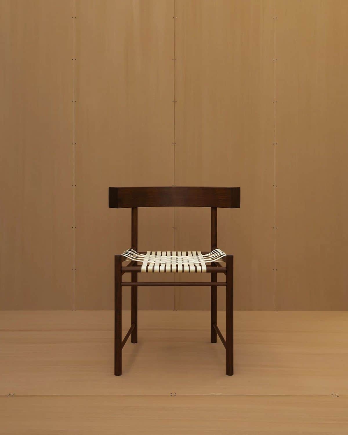 An armless modern side chair featuring a dark-stained solid wood frame and a seat woven with white s… — free GLTF 3D model
