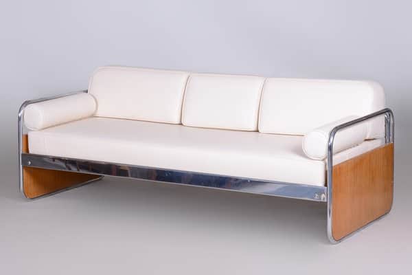 A three-seater sofa characterized by its tubular chrome frame, light wood end panels, and white upho… — free GLTF 3D model