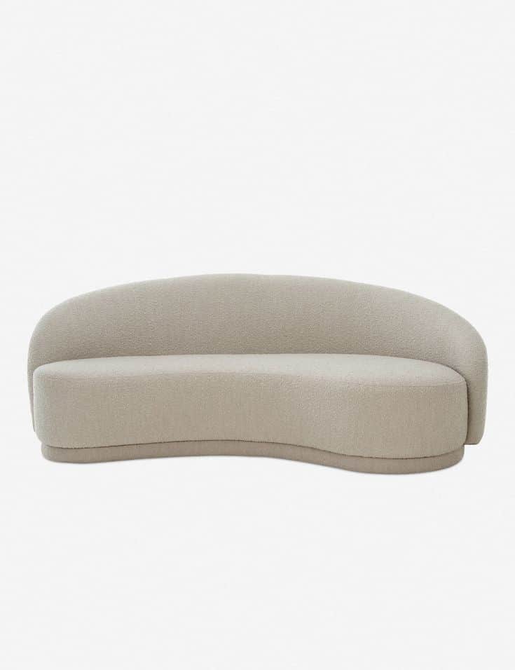 A contemporary curved sofa upholstered in a light beige bouclé fabric, featuring a continuous low-sl… — 3D model