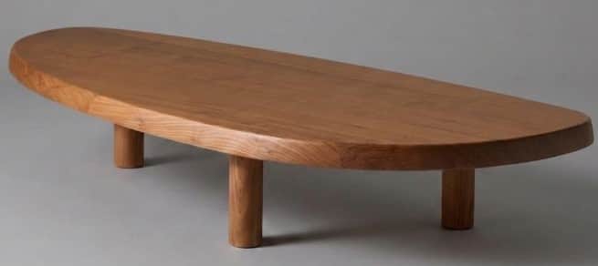 A low-slung wooden coffee table with an elongated, organic oval-shaped top and four thick, cylindric… — 3D model