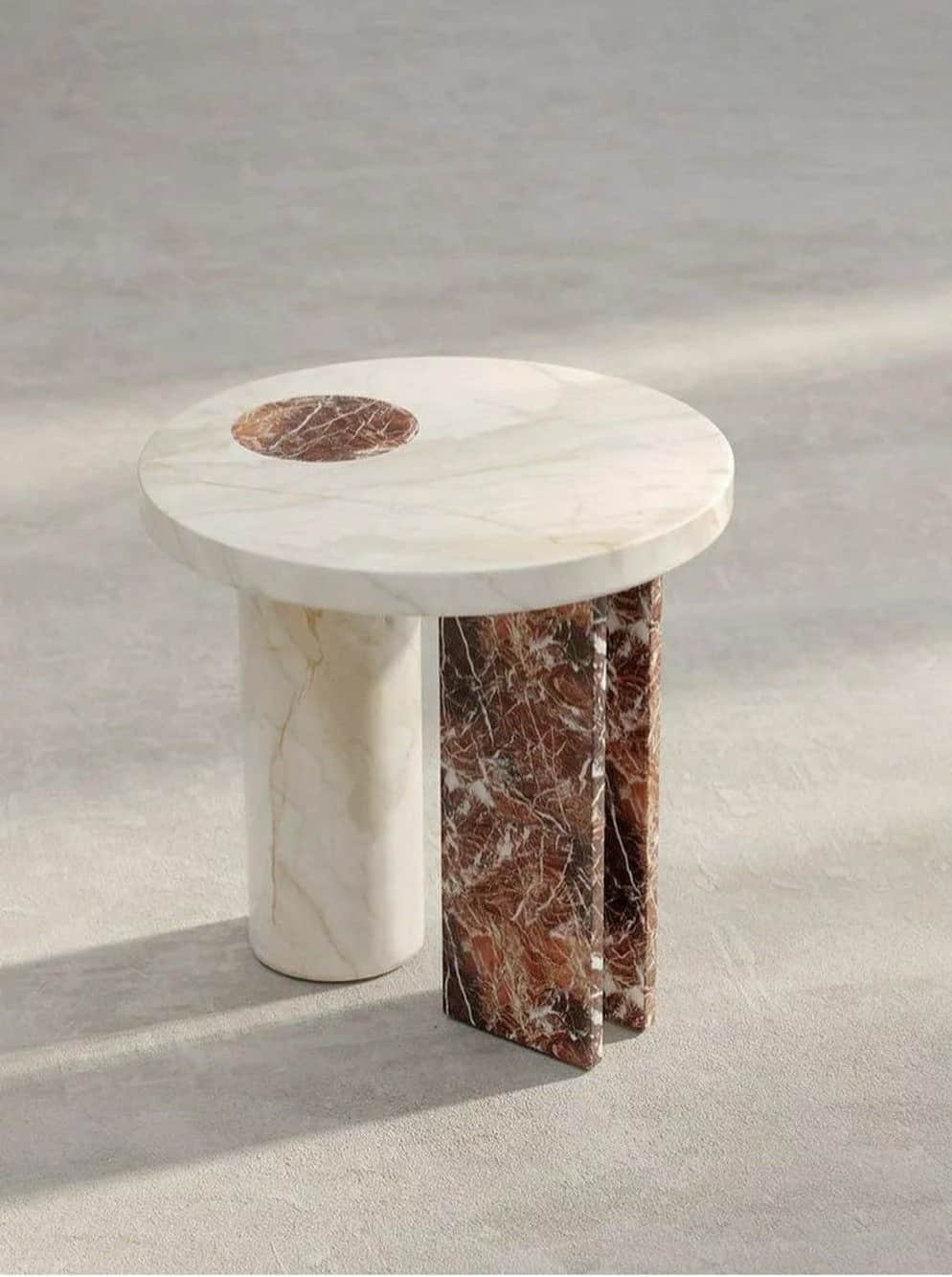 A round side table crafted from two distinct types of marble, featuring a cream-colored top with a r… — 3D model