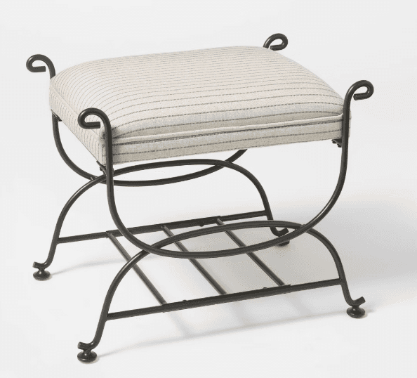 A rectangular upholstered stool featuring a dark-finished wrought iron frame with an X-shaped base.… — 3D model