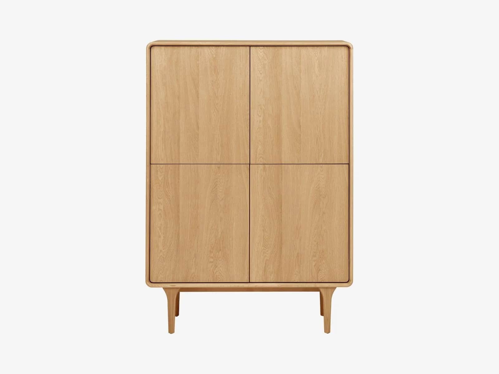 A freestanding, light-toned wooden storage cabinet featuring four solid doors arranged in a two-by-t… — 3D model
