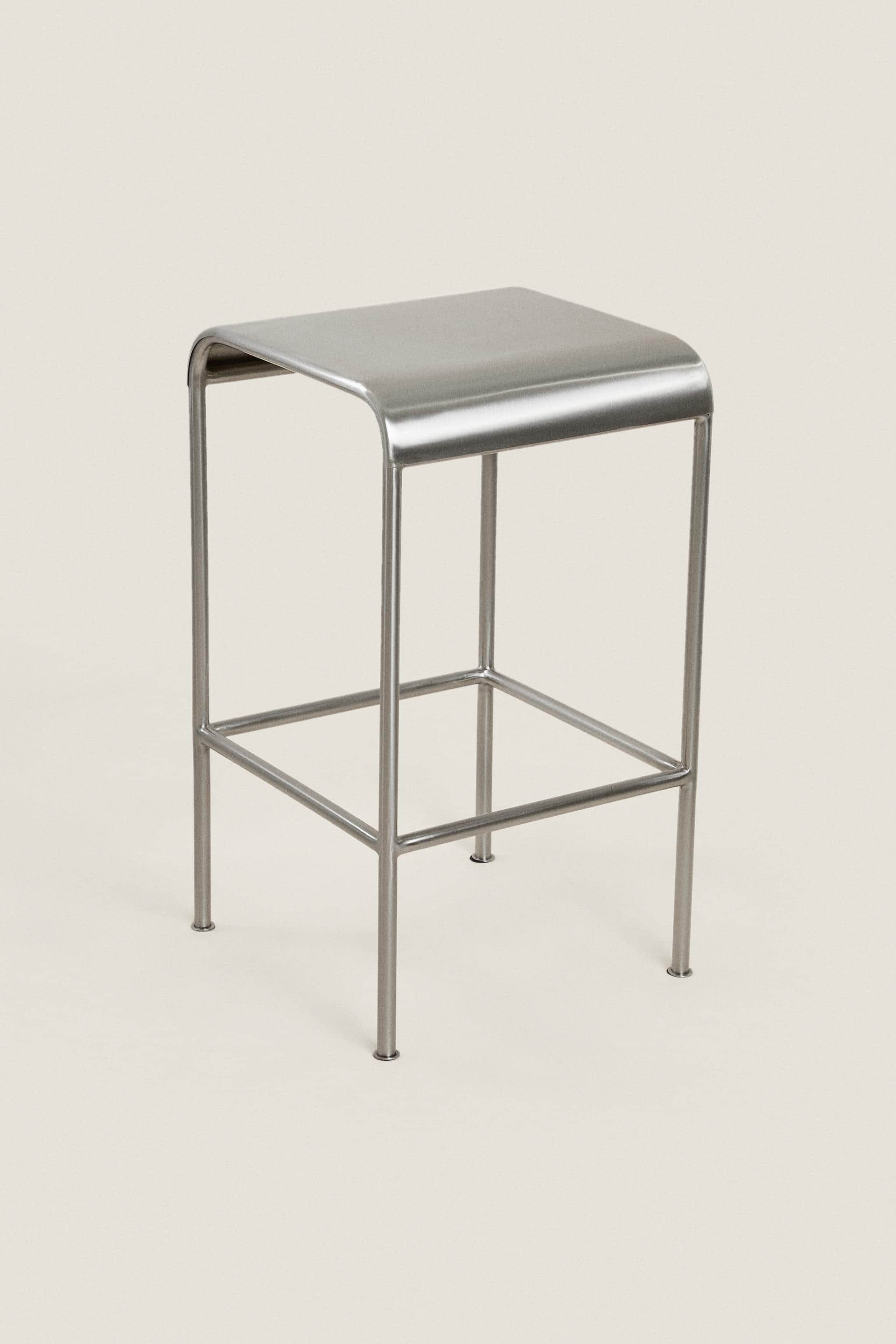 A minimalist, square-top stool constructed entirely from brushed stainless steel. It features a soli… — 3D model