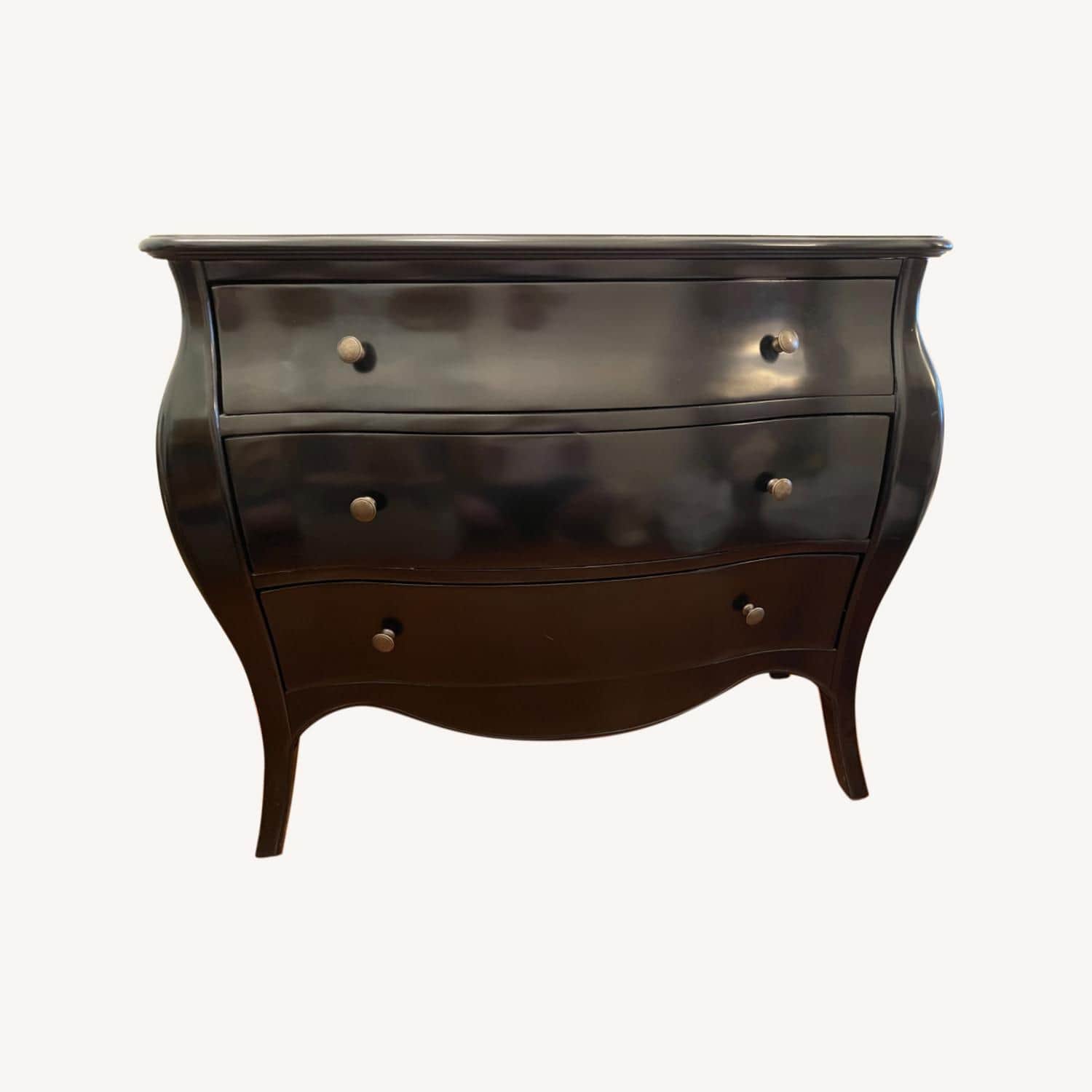 A dark-finished bombe chest of drawers featuring a serpentine top and three bowed drawers, each fitt… — 3D model