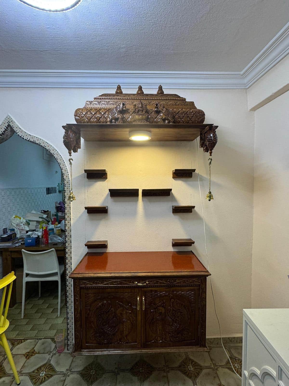 A dark wooden display cabinet with ornate carvings on the doors and sides. It features a textured or… — free FBX 3D model