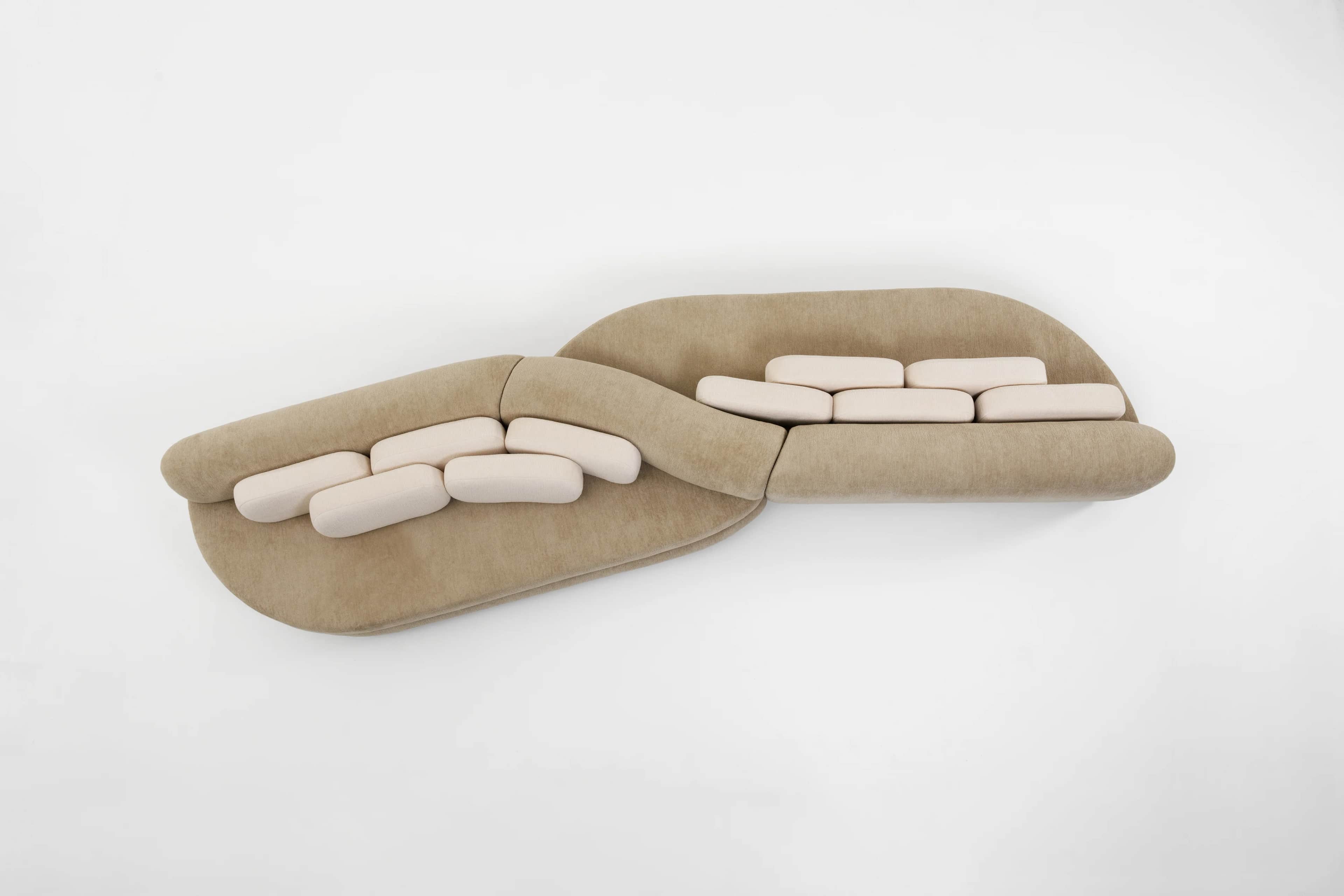 A contemporary curved modular sectional sofa featuring a beige upholstered base and lighter, off-whi… — 3D model