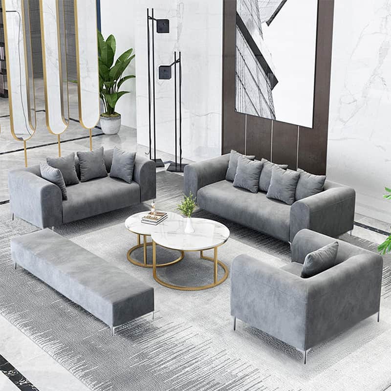 A modern, three-seater sofa upholstered in a grey fabric, featuring rounded track arms, loose back c… — 3D model