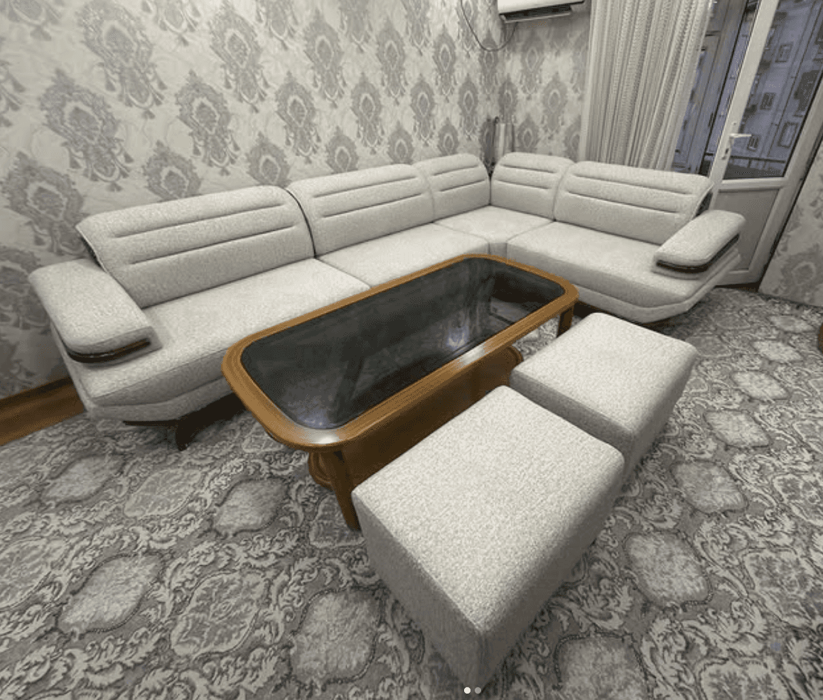 An L-shaped sectional sofa set featuring light gray fabric upholstery, integrated dark wood armrest… — free SKP 3D model