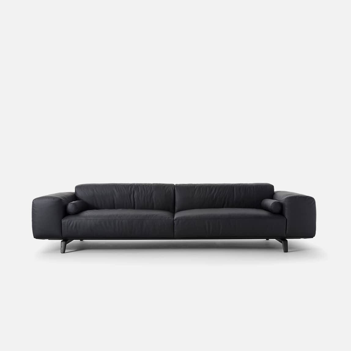 A contemporary three-seater sofa upholstered in black leather, featuring a low profile, clean lines,… — 3D model