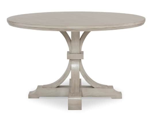 A round pedestal dining table with a light-colored finish. The table features a thick, banded tablet… — 3D model