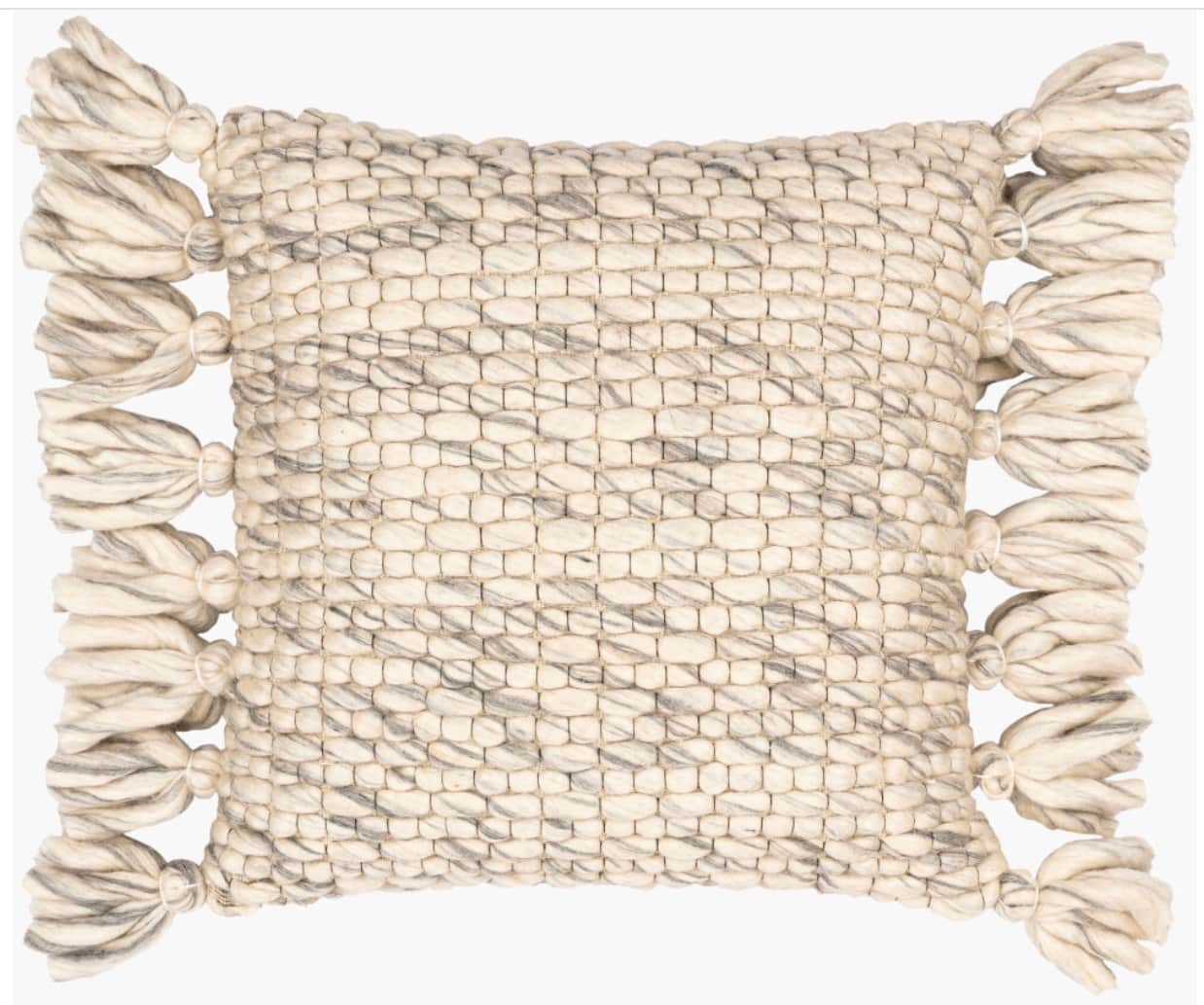 A square pillow with a textured weave and tassels along two adjacent sides. The pillow features a pr… — 3D model